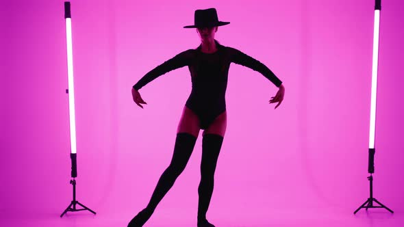 Seductive Dancer Woman in Hat Bodysuit and Stockings Dancing Modern Elements