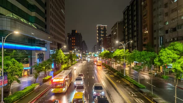 Traffic in Taipei City at Night in Taiwan. Timelapse of Transport Moving Along Illuminated Street