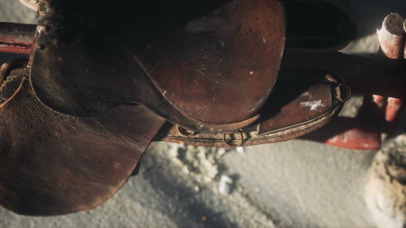 Rider Leather Saddle on Fence in Desert