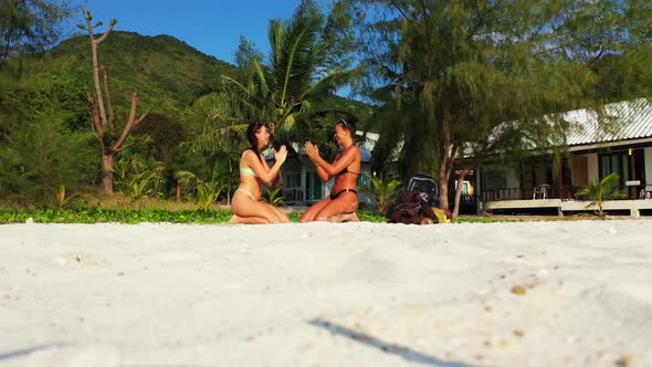 Girls happy together on luxury shore beach break by blue sea and white sand background of Thailand n