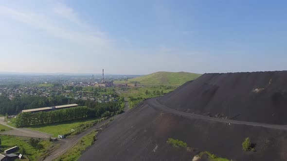 Aerial view of Huge slag dump next to residential buildings and vegetable gardens 08