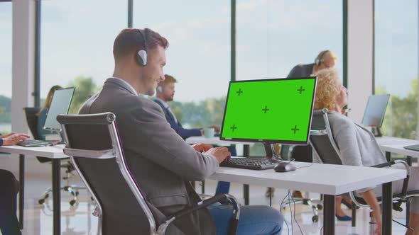 Man with headphones working on computer