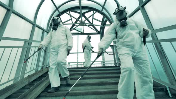 Group of Sanitary Inspectors Are Disinfecting the Staircase. Disinfection, Antivirus Protective