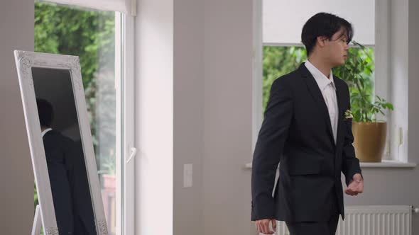 Handsome Confident Asian Groom in Wedding Suit Leaving in Slow Motion Indoors