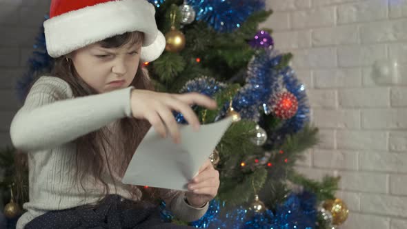 Sad Child at Christmas with a Letter