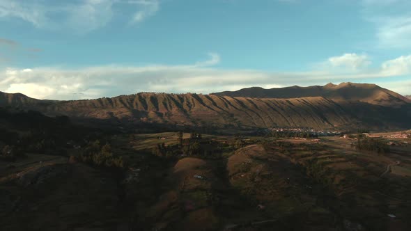 4k aerial drone footage over the Northern hills and mountains of Cusco in Peru at sunset. Pan from r