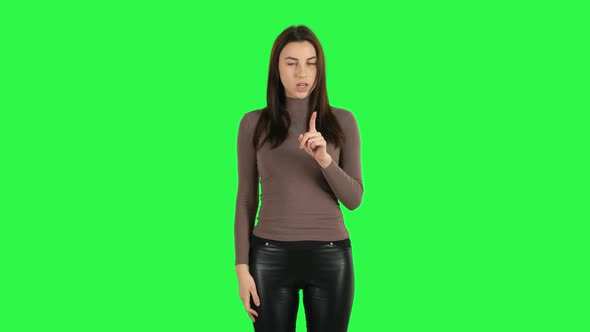 Attractive Girl Talking About Something Then Making a Hush Gesture, Secret. Green Screen
