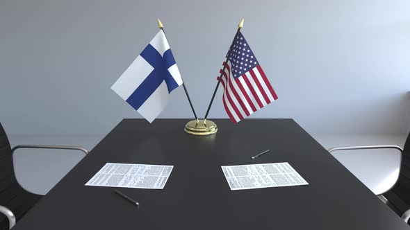 Flags of Finland and the United States and Papers on the Table