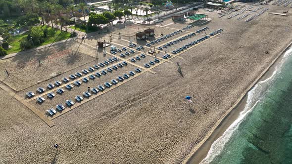 Empty sun loungers on the beach aerial view 4 K Turkey Alanya