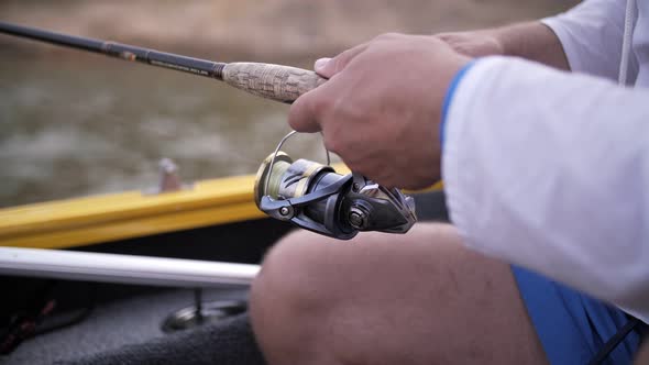 fishing rod in the hands of a man close-up