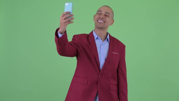 Happy Bald Multi Ethnic Businessman Taking Selfie