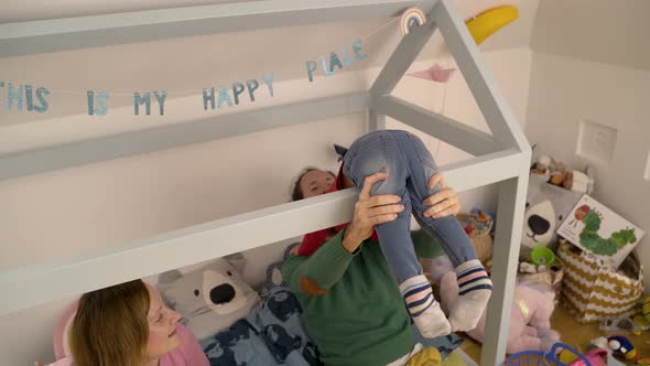 Family playing together at children room during the morning light.