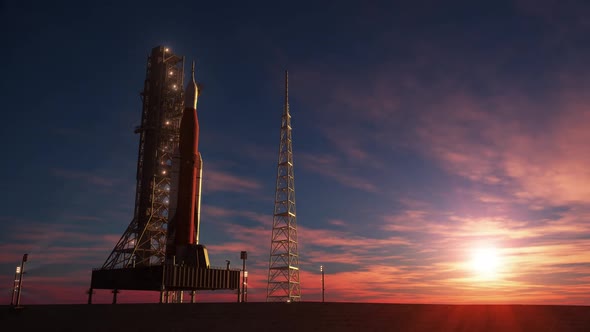 Big heavy rocket on launchpad on the background of sunrise
