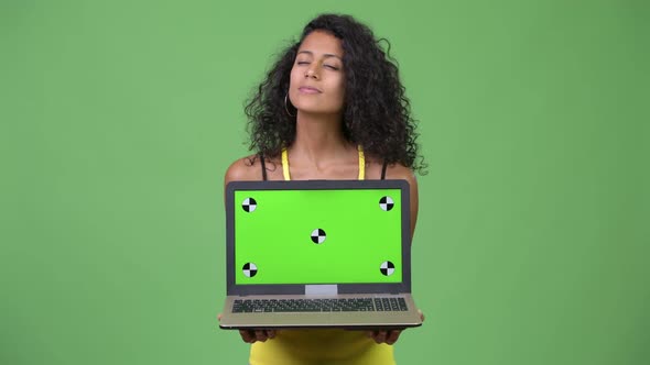 Young Beautiful Hispanic Woman Thinking While Showing Laptop