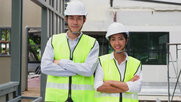 Portrait of Asian workers people wearing protective safety helmet and work onsite of architecture.