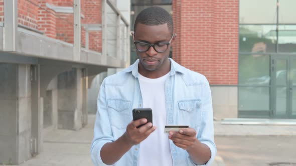 African Man Having Online Payment Failure on Smartphone in Street