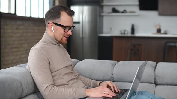 Happy Fit Young Bearded Hipster Man in Glasses Has Video Call