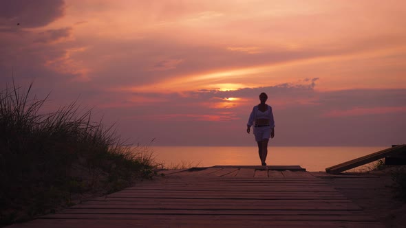 Silhouette of a Slender Woman at Sunset