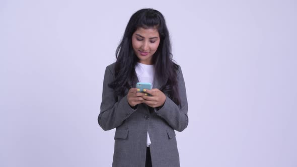 Young Happy Persian Businesswoman Thinking While Using Phone