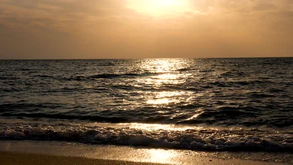 Sea at the Sunrise with Sun Rays Reflection on the Water