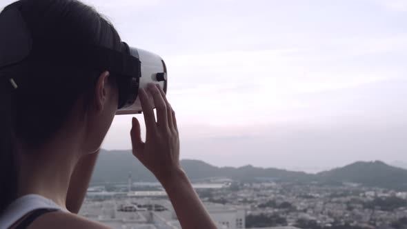 Woman watching with virtual reality device at outdoor 