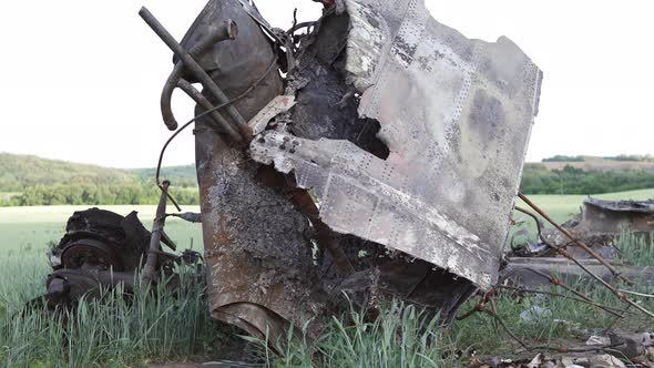 Downed military transport aircraft in a wheat field. Russian aggression in Ukraine.