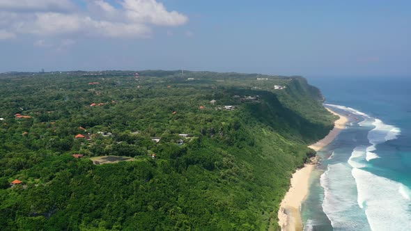 aerial panoramic of Uluwatu Cliffs in Bali Indonesia at Nyang Nyang Beach on sunny day