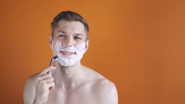 Smiling Young Man Shaves His Beard Looks Camera Isolated Studio Background