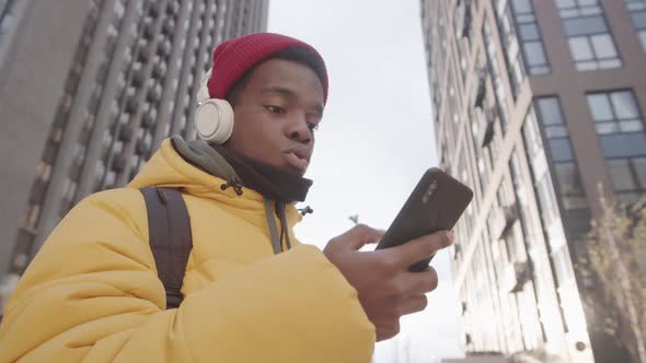 African Student Using Devices in City Center