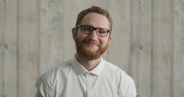 Portrait of an Attractive Bearded Young Man with Glasses