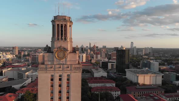 Slow flyback of the UT tower on campus in Austin TX. Shot starts with the tower framed with downtown