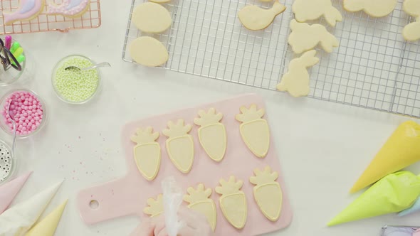 Step by step. Flat lay. Decorating Easter sugar cookies with royal icing