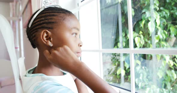 Girl in fairy costume looking through window 4k