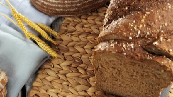 Sliced bread loaf with wheat grains and knife