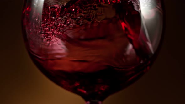 Super Slow Motion Detail Shot of Pouring Red Wine on Luxury Gradient Background at 1000Fps