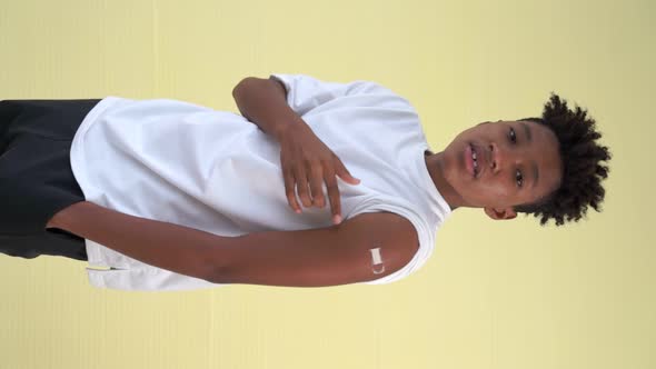 Vertical Video of African Teenager Showing COVID19 Vaccine Bandage Merrily