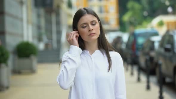 Hands Holding Clapperboard in Front of Woman Wearing Wireless Headphones, Scene