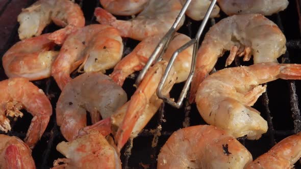 Closeup of Large Grilled Shrimps Grilling and Rotating on the Grill Grid