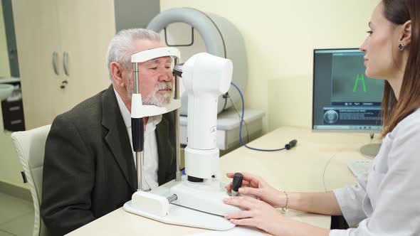 Ophthalmologist Examination of Elderly Man on Corneo Topographer