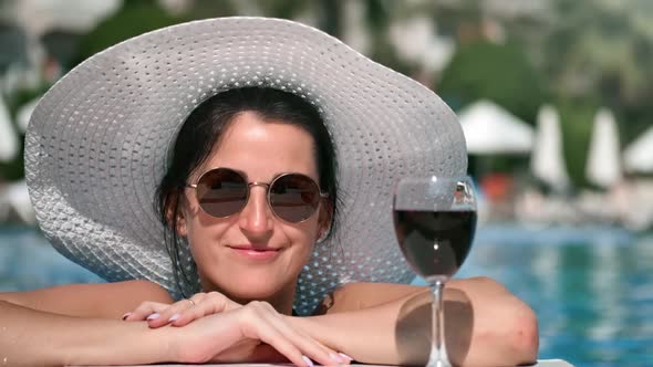 Closeup Tourist Female Smiling Posing with Wine Bocal at Swimming Pool Enjoying Summer Holiday