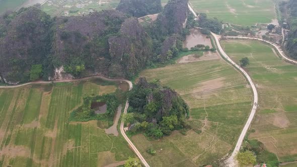 Aerial shot of large limestone karsts in Vietnamese countryside. Tam Coc, Ninh Binh, Vietnam