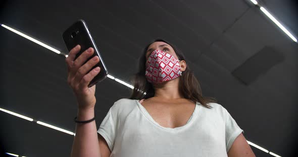 Female at Metro Wearing Mask Using Cellphone