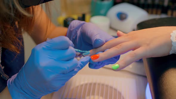 Master of Manicure Getting Professional Manicure in Beauty Salon Woman Puts Nail Polish