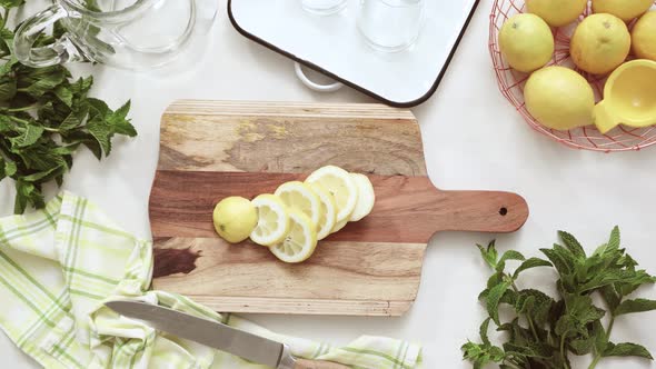 Sliced organic lemon on wood cutting board.
