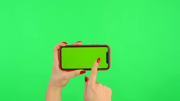 Woman Holds Mobile Phone with Workspace Mock Up Screen in Her Hands on Green Background in