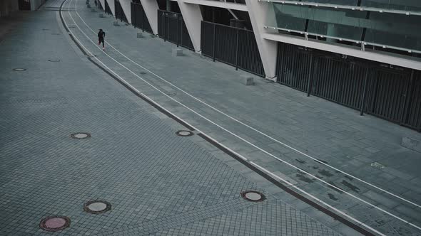 Top View at Outdoor Training Track Near Stadium and African American Man Running Fastly on It