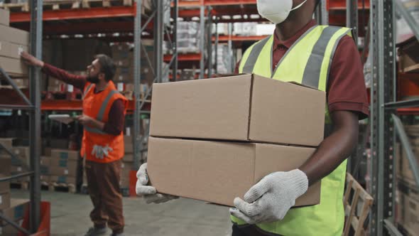 Mid-Section of Warehouse Worker with Boxes