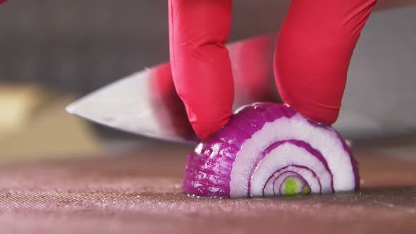 Macro Chef Cut Onion Into Thin Slices with Sharp Metal Knife