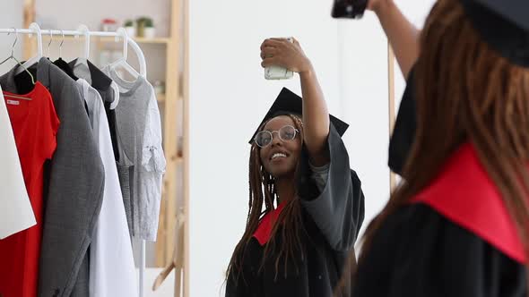 Graduate African American Woman Talking Selfie Portrait Photo of Herself Wearing Cap and Gown Spbi