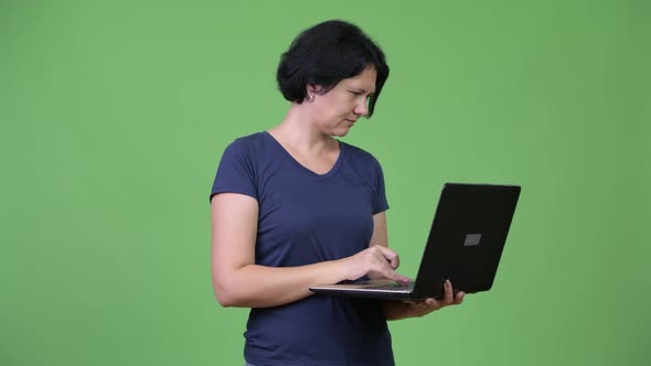 Beautiful Woman with Short Hair Using Laptop